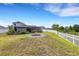 Beautiful backyard with a fire pit, lush lawn, and a screened-in lanai, creating a private retreat at 1657 Bonita Bluff Ct, Ruskin, FL 33570