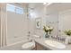 Bright bathroom features a shower-tub combo, and a vanity with decor and a large mirror at 1657 Bonita Bluff Ct, Ruskin, FL 33570