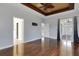 Spacious primary bedroom featuring wood floors, a ceiling fan, and access to the patio at 1657 Bonita Bluff Ct, Ruskin, FL 33570