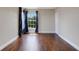 Room features hardwood floors, a bright window, and stylish curtains, creating a cozy atmosphere at 1657 Bonita Bluff Ct, Ruskin, FL 33570