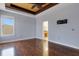 Bedroom features wood floors, a ceiling fan, and an attached bathroom and walk-in closet at 1657 Bonita Bluff Ct, Ruskin, FL 33570