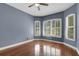 Lovely bedroom with a ceiling fan, rich wood flooring, and bright windows with white shutters at 1657 Bonita Bluff Ct, Ruskin, FL 33570
