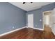 Comfortable bedroom with gleaming wood flooring, closet, and a view to the hallway at 1657 Bonita Bluff Ct, Ruskin, FL 33570