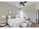 This bedroom is well decorated with light-colored furniture, a window, and hardwood floors at 1657 Bonita Bluff Ct, Ruskin, FL 33570