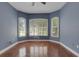 Inviting bedroom with wood floors, bright windows with shutters, and natural light at 1657 Bonita Bluff Ct, Ruskin, FL 33570