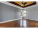 A bright bedroom with wood floors, two large windows, and contemporary neutral walls at 1657 Bonita Bluff Ct, Ruskin, FL 33570