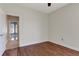 Bedroom with wood flooring, natural light, and an open doorway view to the house interior at 1657 Bonita Bluff Ct, Ruskin, FL 33570