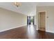 A spacious living room boasts hardwood floors, large windows, and elegant chandelier lighting at 1657 Bonita Bluff Ct, Ruskin, FL 33570