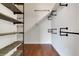 Modern closet features unique industrial shelving and a hanging rack, offering plenty of storage space at 1657 Bonita Bluff Ct, Ruskin, FL 33570
