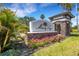 Entrance to the Mira Lago community with stone accents and lush landscaping at 1657 Bonita Bluff Ct, Ruskin, FL 33570