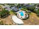 Aerial view of sparkling community pool with tennis court, clubhouse, and lounge chairs for residents to enjoy at 1657 Bonita Bluff Ct, Ruskin, FL 33570