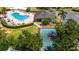 Aerial view showcasing the community pool, clubhouse, tennis court and ample seating for residents at 1657 Bonita Bluff Ct, Ruskin, FL 33570