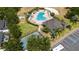 Aerial view showcasing the community pool, clubhouse, tennis court, and convenient parking at 1657 Bonita Bluff Ct, Ruskin, FL 33570