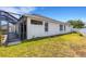 Exterior view of home showing enclosed back patio, lawn and windows at 1657 Bonita Bluff Ct, Ruskin, FL 33570