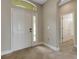 Bright foyer featuring tile floors, a white front door with a window, and an open entryway at 1657 Bonita Bluff Ct, Ruskin, FL 33570