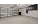 Spacious garage with ample storage space, a vacuum, and an automatic garage door at 1657 Bonita Bluff Ct, Ruskin, FL 33570