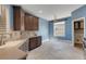 Open-concept kitchen featuring a window, blue walls, and dark wood cabinetry, exuding elegance at 1657 Bonita Bluff Ct, Ruskin, FL 33570