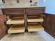 Kitchen cabinet features pull-out shelving for organized storage within beautiful brown cabinets at 1657 Bonita Bluff Ct, Ruskin, FL 33570