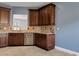 Kitchen featuring stainless steel appliances, dark wood cabinets, and sleek tiled flooring at 1657 Bonita Bluff Ct, Ruskin, FL 33570