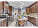 Beautiful kitchen with dark wood cabinetry, stainless steel appliances, and a center island with barstool seating at 1657 Bonita Bluff Ct, Ruskin, FL 33570