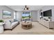 Bright living room features neutral decor, contemporary furnishings, and sliding glass doors to the outdoors at 1657 Bonita Bluff Ct, Ruskin, FL 33570