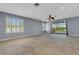 Open-concept living room featuring tile floors, recessed lighting, and sliding glass doors to the outdoor space at 1657 Bonita Bluff Ct, Ruskin, FL 33570