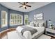 A bedroom featuring multiple windows, a ceiling fan, and a cozy bed at 1657 Bonita Bluff Ct, Ruskin, FL 33570