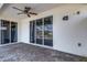 Spacious brick patio with ceiling fan features glass sliding doors to the interior of the home at 1657 Bonita Bluff Ct, Ruskin, FL 33570