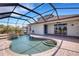 Relax in this screened-in pool with built-in spa, waterfall feature, and outdoor patio at 1657 Bonita Bluff Ct, Ruskin, FL 33570