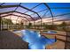 Screened in pool with a connected hot tub and brick pool deck offer a private backyard oasis at 1657 Bonita Bluff Ct, Ruskin, FL 33570