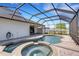 Large pool and spa with brick trim inside a screened-in enclosure and a spacious brick patio at 1657 Bonita Bluff Ct, Ruskin, FL 33570