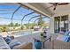 Beautiful screened-in pool area featuring a luxurious pool, a seating area, and a ceiling fan for outdoor comfort at 1657 Bonita Bluff Ct, Ruskin, FL 33570