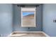 Cozy room featuring stylish tile flooring, a window, and soothing blue walls at 1657 Bonita Bluff Ct, Ruskin, FL 33570