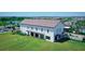 Exterior view of the community clubhouse, featuring a spacious lawn and inviting outdoor space at 17425 Haysack Ter, Lakewood Ranch, FL 34211