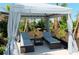 Relaxing pool cabana with comfortable lounge chairs and privacy curtains at 17429 Haysack Ter, Lakewood Ranch, FL 34211