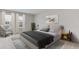 A staged bedroom features large windows, neutral tones, and lots of natural light at 18114 Metado Dr, Bradenton, FL 34211