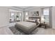 A modern main bedroom features a sitting area, neutral tones, and lots of natural light at 18114 Metado Dr, Bradenton, FL 34211