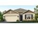 Charming one-story home featuring beige siding, a two-car garage, and a well-manicured front lawn at 18219 Wheathouse Pl, Lakewood Ranch, FL 34211