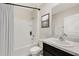The bathroom features a shower with white tile, a shower curtain, and a vanity sink with countertop at 18220 Canopy Pl, Lakewood Ranch, FL 34211