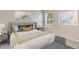 Cozy bedroom with large window and decorative art pieces and side tables at 18220 Canopy Pl, Lakewood Ranch, FL 34211