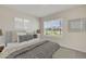 Bright bedroom with a large window and neutral decor and a grey bench at 18220 Canopy Pl, Lakewood Ranch, FL 34211