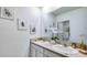 Bathroom featuring double sinks with white cabinets and a large mirror at 18223 Canopy Pl, Lakewood Ranch, FL 34211