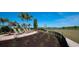 Tranquil lakeside seating area with comfortable chairs, landscaping, and serene views, perfect for relaxation at 18223 Wheathouse Pl, Lakewood Ranch, FL 34211