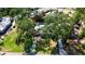 Aerial view of house featuring a pool, mature trees, driveway, and manicured lawn at 1830 Virginia Dr, Bradenton, FL 34205