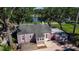 Aerial view of house from backyard featuring a deck and lush greenery at 1830 Virginia Dr, Bradenton, FL 34205