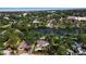 Stunning aerial view of home near lake with lush green trees and landscaping throughout neighborhood at 1830 Virginia Dr, Bradenton, FL 34205