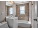 Well-lit bathroom showcasing decorative tile, a bathtub, and modern fixtures at 1830 Virginia Dr, Bradenton, FL 34205