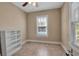 Bedroom with a ceiling fan, neutral colored walls, and tile flooring at 1830 Virginia Dr, Bradenton, FL 34205