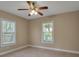 Bright bedroom featuring tiled floor, a ceiling fan and two bright windows at 1830 Virginia Dr, Bradenton, FL 34205