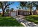 Charming single-story home with an attached garage, a well-maintained lawn and mature trees at 1830 Virginia Dr, Bradenton, FL 34205